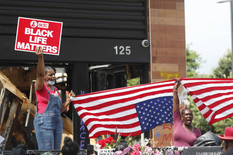 ASSOCIATED PRESS / JUNE 23
                                Protesters chant outside a Wendy’s restaurant in Atlanta after a funeral for Rayshard Brooks was held. Brooks died after being fatally shot by an Atlanta police officer.