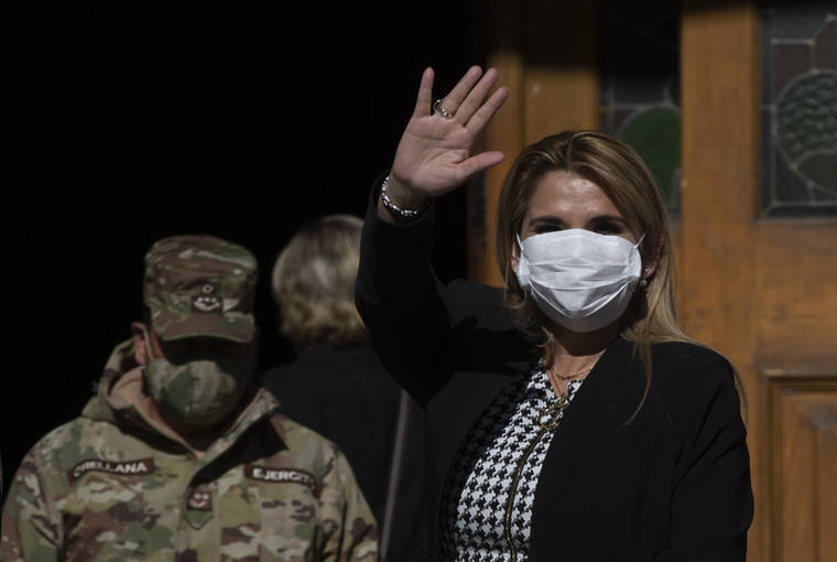 ASSOCIATED PRESS
                                Bolivia’s interim President Jeanine Anez, wearing a face mask to help curb the spread of the new coronavirus, waves during a procession Corpus Christi, in La Paz, Bolivia, Thursday, June 11, 2020. Anez has announced today that she has tested positive for COVID-19.
