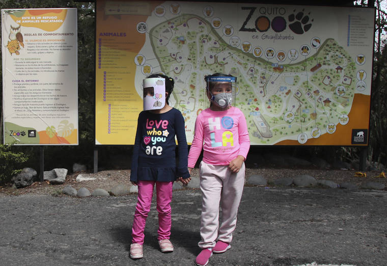 ASSOCIATED PRESS
                                Girls wearing face shields as a preventive measure against the new coronavirus wait for their parents to enter the zoo on the outskirts of Quito, in Guayllabamba, Ecuador. The zoo is reopening but with strict new social distancing protocols for visitors due to the COVID-19 pandemic.