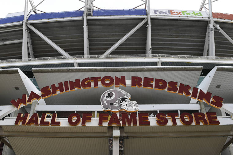 ASSOCIATED PRESS
                                Signs for the Washington Redskins were displayed outside FedEx Field in Landover, Md., today. The Washington NFL franchise announced today that it will drop the “Redskins” name and Indian head logo immediately, bowing to decades of criticism that they are offensive to Native Americans.