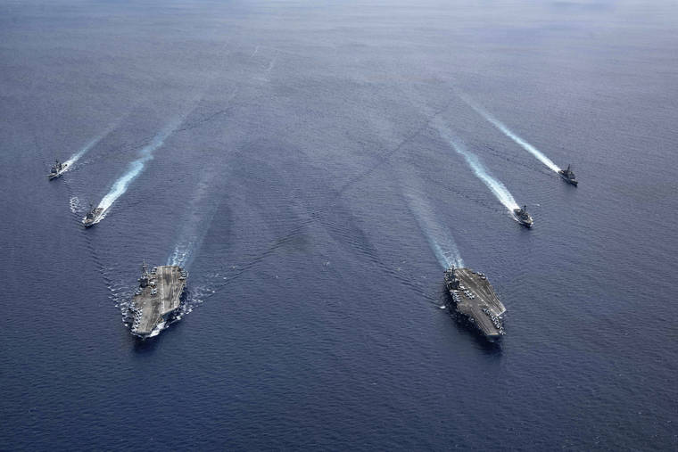 MASS COMMUNICATION SPECIALIST 3RD CLASS JASON TARLETON/U.S. NAVY VIA ASSOCIATED PRESS
                                The USS Ronald Reagan (CVN 76) and USS Nimitz (CVN 68) Carrier Strike Groups steamed in formation, in the South China Sea, July 6. China, on July 6, accused the U.S. of flexing its military muscles in the South China Sea by conducting joint exercises with two U.S. aircraft carrier groups in the strategic waterway.