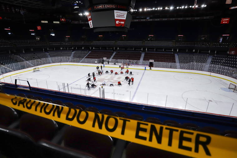 ASSOCIATED PRESS
                                Calgary Flames’ players take to the ice during NHL hockey practice in Calgary, Alberta, today.