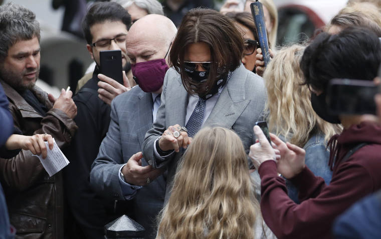 ASSOCIATED PRESS
                                Actor Johnny Depp, center, was surrounded by fans as he arrived at the High Court in London, today. Depp is suing News Group Newspapers, publisher of The Sun, and the paper’s executive editor, Dan Wootton, over an April 2018 article that called him a “wife-beater.”