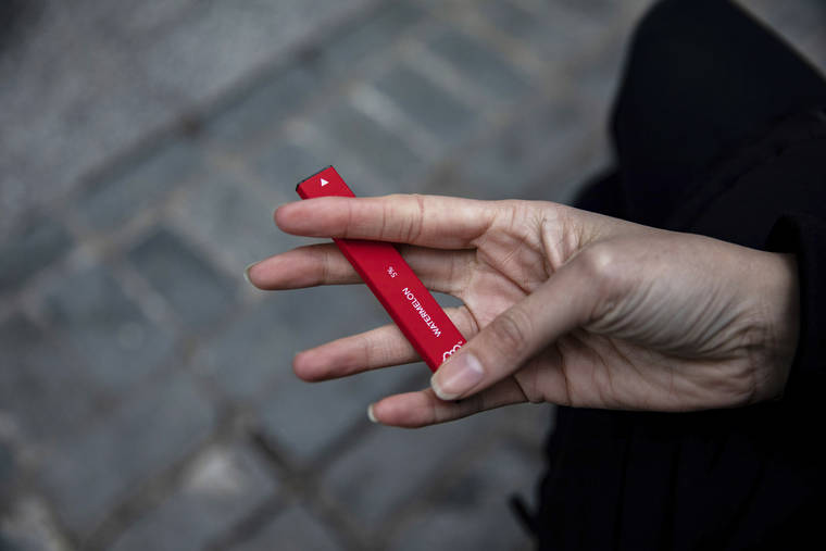ASSOCIATED PRESS
                                A woman holds a Puff Bar flavored disposable vape device in New York in January. U.S. health officials are cracking down on the brand of fruity disposable e-cigarettes that is popular with teenagers, saying the company never had permission to launch in the U.S.
