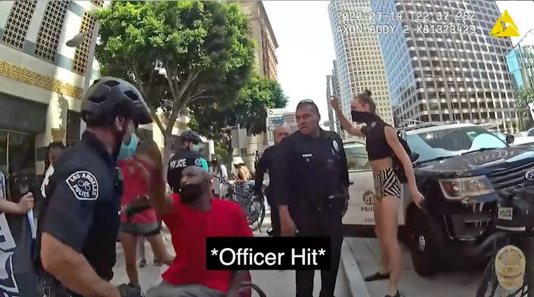 ASSOCIATED PRESS
                                This photo from police body camera video released by the Los Angeles Police Department shows a confrontation on July 14 between officers and a man in a wheelchair hitting an officer in the face in what authorities say prompted his arrest where he was knocked to the ground and out of his wheelchair amid a struggle.