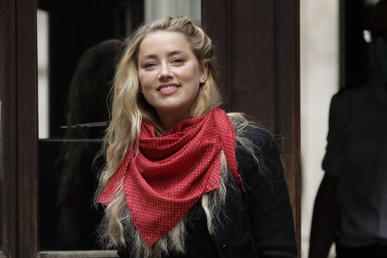 ASSOCIATED PRESS
                                American actress Amber Heard smiles at the media as she arrives at the High Court in London today. Actor Johnny Depp is suing News Group Newspapers, publisher of The Sun, and the paper’s executive editor, Dan Wootton, over an April 2018 article that called him a “wife-beater.” Depp strongly denies all allegations.