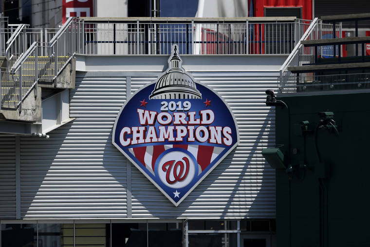 ASSOCIATED PRESS
                                A 2019 World Series champions sign is displayed during the Washington Nationals baseball practice at Nationals Park, Wednesday, in Washington.