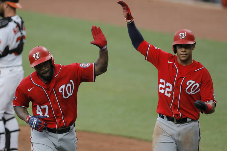 ASSOCIATED PRESS
                                Washington Nationals’ Howie Kendrick (47) is greeted with “air high fives” by Juan Soto (22) after Kendrick scored them both on a two-run home run off Baltimore Orioles starting pitcher Alex Cobb during an exhibition baseball game Monday in Baltimore.