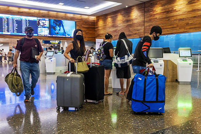 STAR-ADVERTISER / JUNE 24
                                Travelers check in and head to their departing flights at the Daniel K. Inouye International Airport in Honolulu last month. The state saw 2,296 airline passenger arrivals on Saturday, including 635 returning residents and 600 tourists.