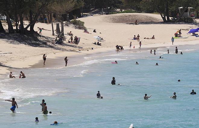 JAMM AQUINO /JAQUINO@STARADVERTISER.COM
                                Beach-goers enjoy the ocean at Kailua Beach Park on Monday, June 29, 2020 in Kailua. State and county officials are urging the public to continue to practice social distancing and to wear face masks as they head out for the Fourth of July holiday weekend.