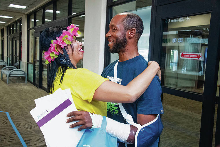 CRAIG T. KOJIMA / CKOJIMA@STARADVERTISER.COM
                                Earnest Brown was greeted by his mother, Alyna Brown-Lewis, on Saturday at Daniel K. Inouye International Airport.