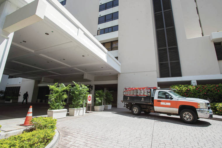 CINDY ELLEN RUSSELL / CRUSSELL@STARADVERTISER.COM
                                The entrance to Hale­kulani Hotel, pictured Tuesday, remains barricaded since its closure due to the COVID-19 pandemic. The luxury Waikiki hotel is set to undergo renovations and isn’t expected to reopen until July 2021.