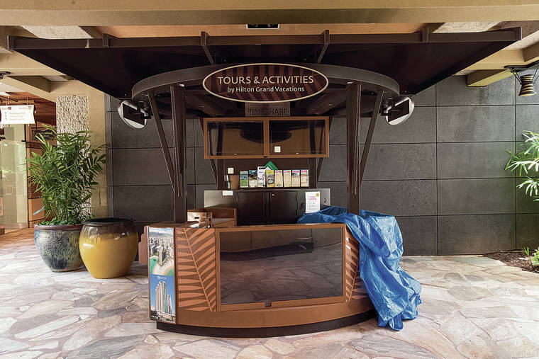CINDY ELLEN RUSSELL / CRUSSELL@STARADVERTISER.COM
                                Businesses dependent on tourism have been struggling through the pandemic. Pictured on Monday is an empty Hilton Grand Vacations tours and activities kiosk at the Royal Hawaiian Center in Waikiki.