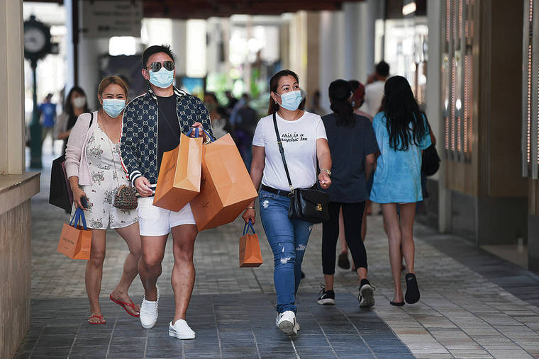 STAR-ADVERTISER / MAY 15
                                Joyce Pascua, left, walks with cousins Emman Calaycay and his sister Eden Calaycay, each with shopping bags and all wearing their face masks, after Mayor Kirk Caldwell gave the OK for businesses to reopen.