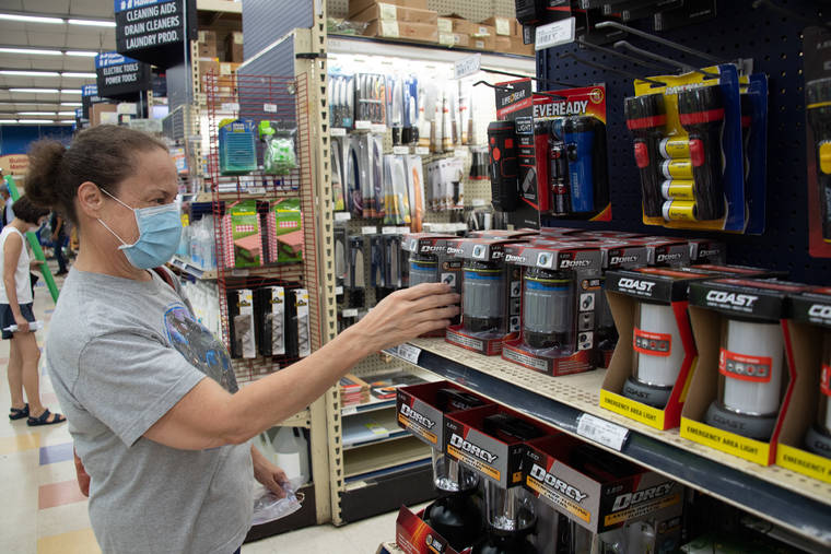 CRAIG T. KOJIMA / CKOJIMA@STARADVERTISER.COM
                                Cheryl Bright looked for a portable light for her emergency equipment at Hardware Hawaii in Kailua on Friday.
