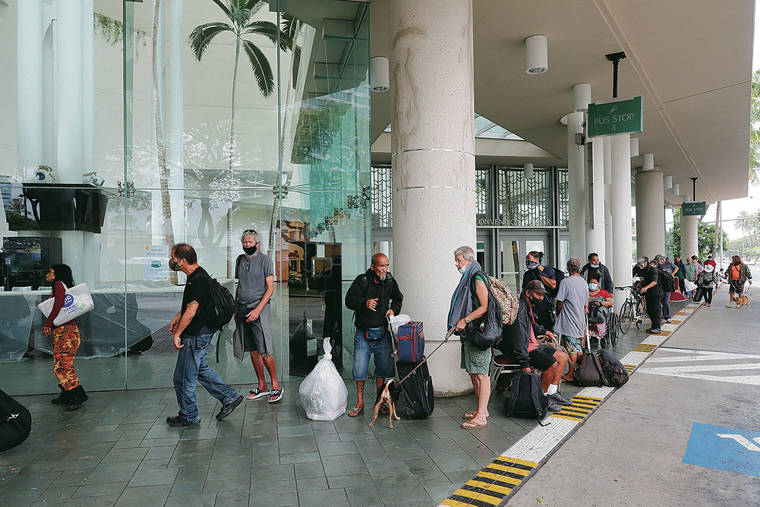 JAMM AQUINO / JAQUINO@STARADVERTISER.COM
                                Evacuees wait to be screened prior to entry into the Hawai’i Convention Center — an American Red Cross shelter set up in advance of Hurricane Douglas — on Sunday.