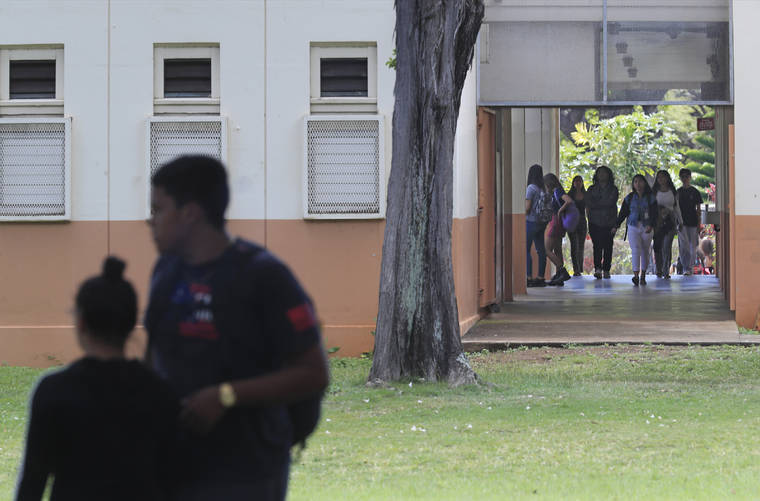 JAMM AQUINO / MARCH 13
                                Hawaii public schools will start the academic year on Aug. 17, nearly two weeks later than planned because of the pandemic. Here, McKinley High School students leave campus after school on March 13.