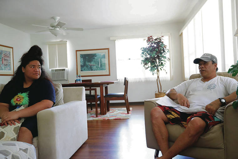 JAMM AQUINO / JAQUINO@STARADVERTISER.COM
                                Rita Polevia, 16, left, sat Friday in the living room of their temporary home with her father, Ilalio Polevia. The two have been bouncing between hotels and apartments for temporary housing with the help of grants.