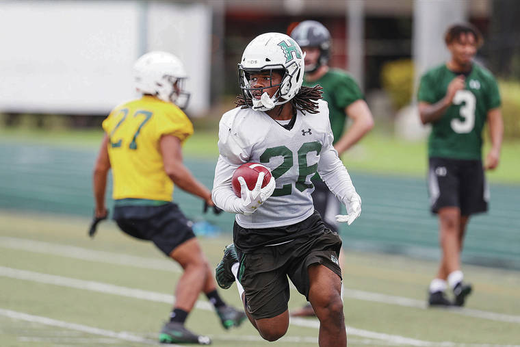 DARRYL OUMI / DECEMBER 14, 2019
                                Hawaii running back Miles Reed looked for yardage during a practice at Clarance T.C. Ching Field on campus.