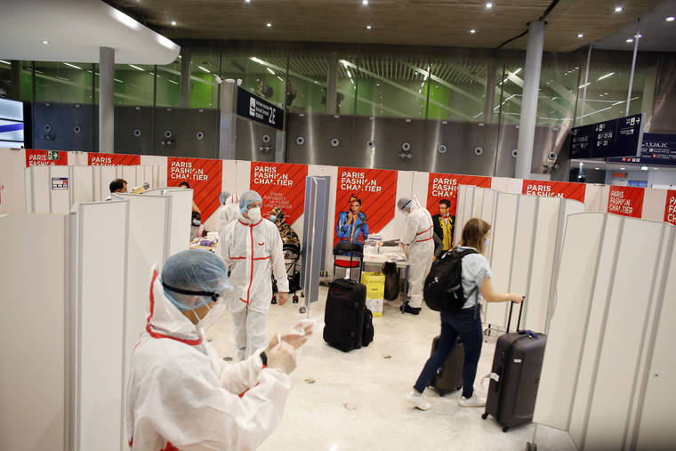 ASSOCIATED PRESS
                                A passenger leaves after being tested with a COVID-19 test, at the Roissy Charles de Gaulle airport, outside Paris. Travelers entering France from 16 countries where the coronavirus is circulating widely are having to undergo virus tests upon arrival at French airports and ports.