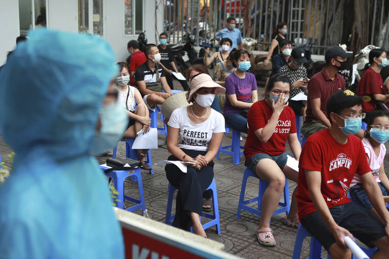 ASSOCIATED PRESS
                                People wait in line for COVID-19 test in Hanoi, Vietnam. Vietnam reported on Friday the country’s first ever death of a person with the coronavirus as it struggles with a renewed outbreak after 99 days without any cases.
