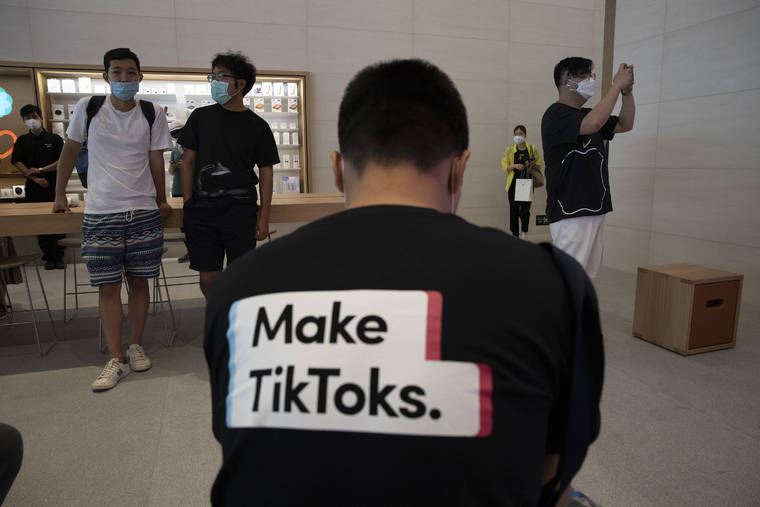 ASSOCIATED PRESS
                                A man wearing a shirt promoting TikTok is seen at an Apple store in Beijing on July 17. U. S. President Donald Trump says he wants to take action to ban TikTok, a popular Chinese-owned video app that has been a source of national security and censorship concerns.