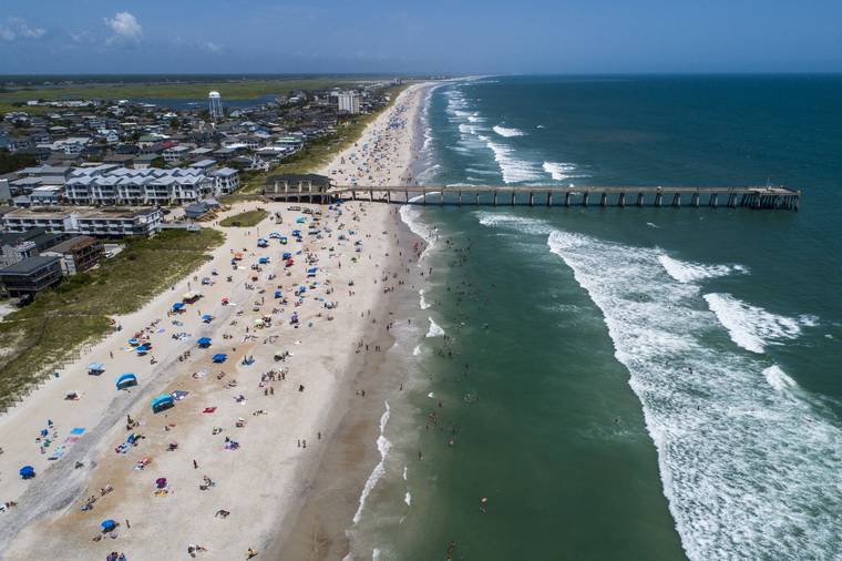 ASSOCIATED PRESS
                                Beachgoers pack Wrightsville Beach, N.C., Sunday as then-Tropical Storm Isaias moves along the Southeast Coast.