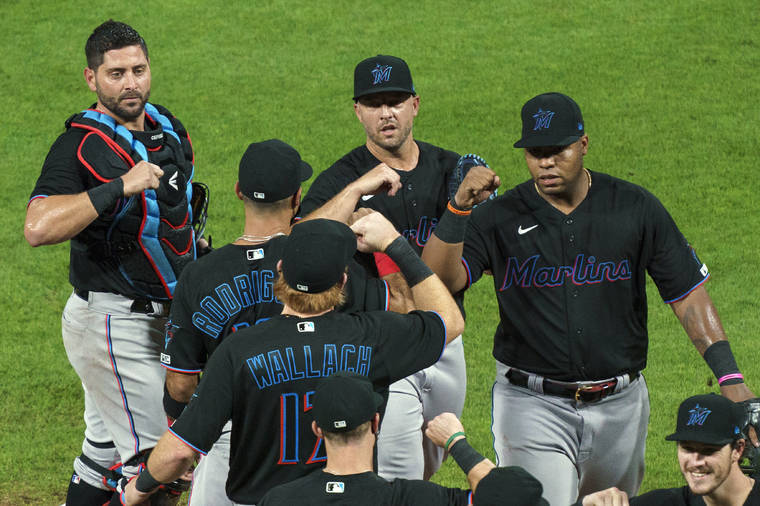 ASSOCIATED PRESS
                                Miami Marlins’ Jesus Aguilar, right, celebrated a win, July 24, with teammates following a baseball game against the Philadelphia Phillies in Philadelphia. Marlins CEO Derek Jeter blamed the team’s coronavirus outbreak on a collective false sense of security that made players lax about social distancing and wearing masks.
