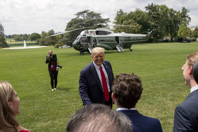 ASSOCIATED PRESS
                                President Donald Trump spoke to guests on the South Lawn before boarding Marine One on the South Lawn of the White House in Washington, today, for a short trip to Andrews Air Force Base, Md. and then on to Cleveland, Ohio.