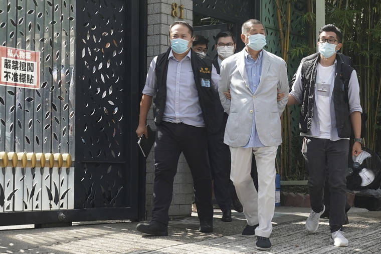 ASSOCIATED PRESS
                                Hong Kong media tycoon Jimmy Lai, center, who founded local newspaper Apple Daily, was arrested by police officers at his home in Hong Kong, Monday. Lai was arrested Monday on suspicion of collusion with foreign powers, his aide said, in the highest-profile use yet of the new national security law Beijing imposed on the city after protests last year.