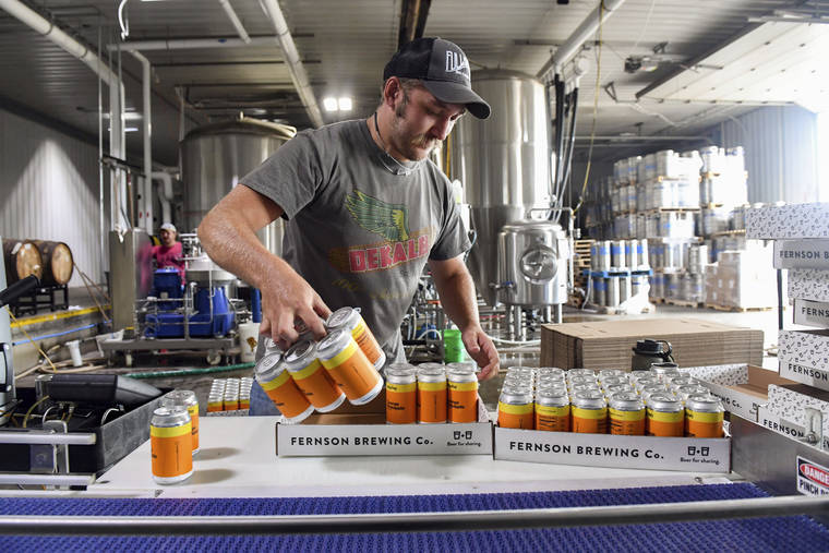 ERIN BORMETT/ARGUS LEADER VIA ASSOCIATED PRESS
                                Jake Gunderson boxes six-packs of Skip Day, a specialty brew, Aug. 3, at Fernson Brewery in Sioux Falls, S.D.