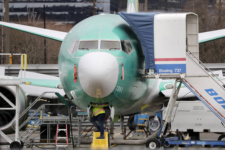 ASSOCIATED PRESS
                                In this 2019 file photo, a worker looks up underneath a Boeing 737 MAX jet, in Renton, Wash.