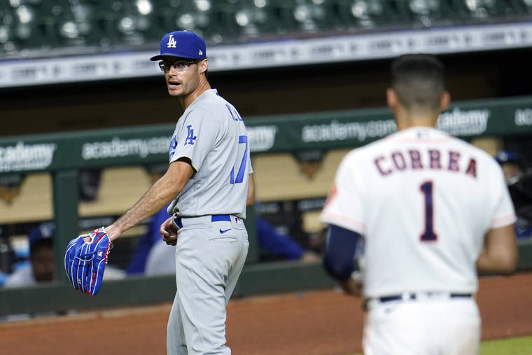 ASSOCIATED PRESS
                                Los Angeles Dodgers relief pitcher Joe Kelly (17) looks back at Houston Astros’ Carlos Correa (1) after the sixth inning of a baseball game on July 28 in Houston. Both benches emptied during the exchange.