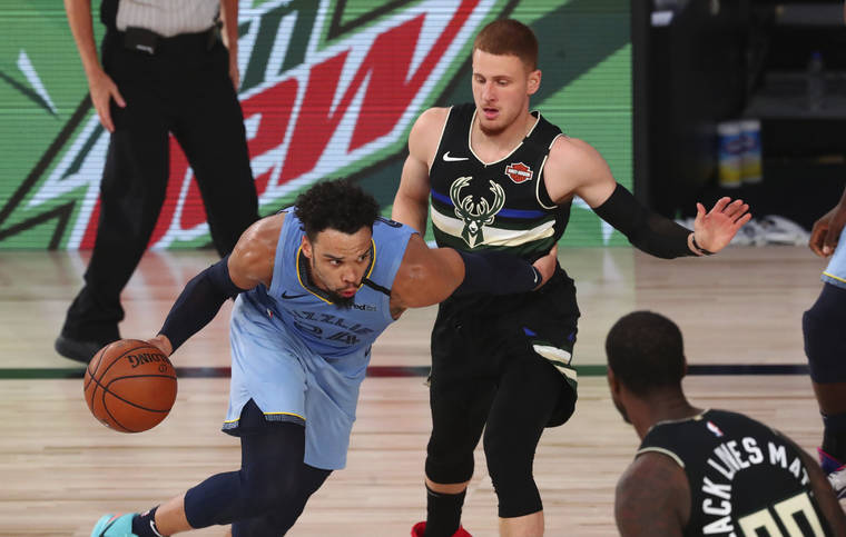 ASSOCIATED PRESS
                                Memphis Grizzlies guard Dillon Brooks (24) drives against Milwaukee Bucks guard Donte DiVincenzo, top right, in the first half of an NBA basketball game today in Lake Buena Vista, Fla.