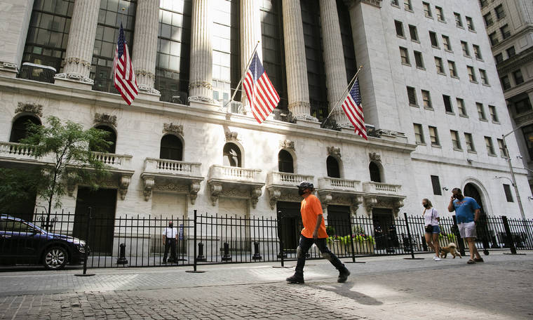 ASSOCIATED PRESS
                                People walked by the New York Stock Exchange on July 21. After a day of drifting between small gains and losses, major stock indexes ended more or less where they started today, but still notched gains for the week.