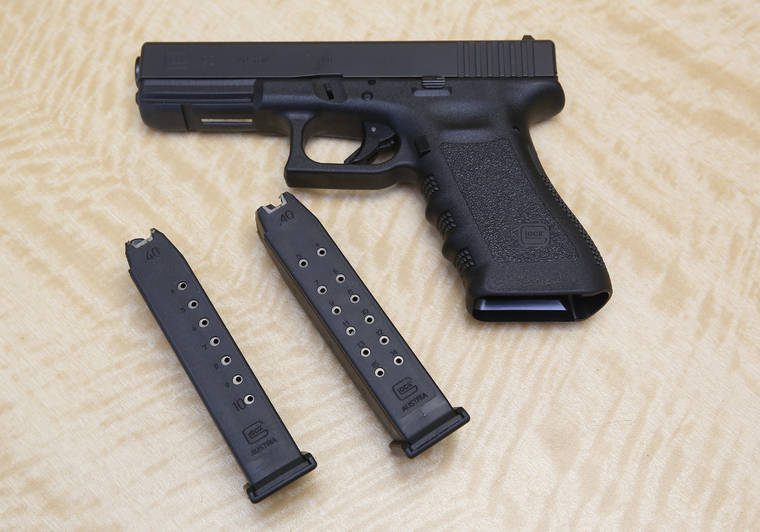 ASSOCIATED PRESS
                                A semi-automatic handgun was displayed, in June 2017, with a 10-shot magazine, left, and a 15-shot magazine, right, at a gun store in Elk Grove, Calif. A three-judge panel of the 9th U.S. Circuit Court of Appeals threw out California’s ban on high-capacity ammunition magazines.