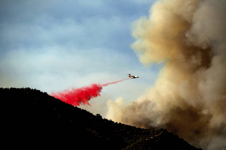 ASSOCIATED PRESS
                                An air tanker drops retardant as the Lake Fire burns in the Angeles National Forest north of Santa Clarita, Calif.