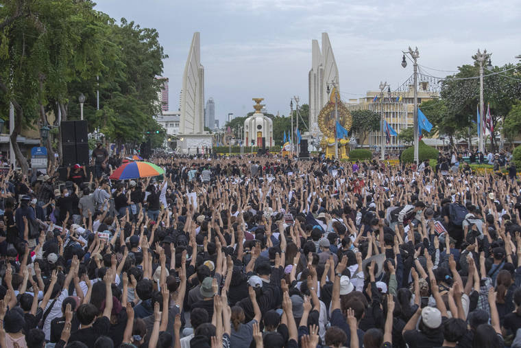 ASSOCIATED PRESS
                                Pro-democracy students raise three-fingers, symbol of resistance salute, during a rally in Bangkok, Thailand, today. Protesters have stepped up pressure on the government if it failed to meet their demands, which include holding of new elections, amending the constitution, and an end to intimidation of critics.