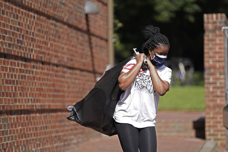 ASSOCIATED PRESS
                                Oyeronke Popoola, a 17-year-old freshman from Raleigh, carried some of her belongings as she and other students left campus following a cluster of COVID-19 cases at The University of North Carolina in Chapel Hill, N.C., Tuesday. The university announced that it would cancel all in-person undergraduate learning starting today.