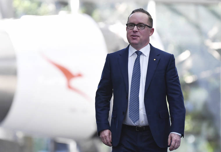 AAP VIA ASSOCIATED PRESS
                                Qantas Chief Executive Officer Alan Joyce walks through the airline’s headquarters following a results announcement in Sydney.