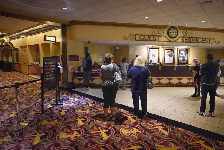 ASSOCIATED PRESS
                                Patrons gather to get tickets for some of the first showings at the AMC theatre when it re-opened for the first time since shutting down at the start of the COVID-19 pandemic on Thursday in West Homestead, Pa.