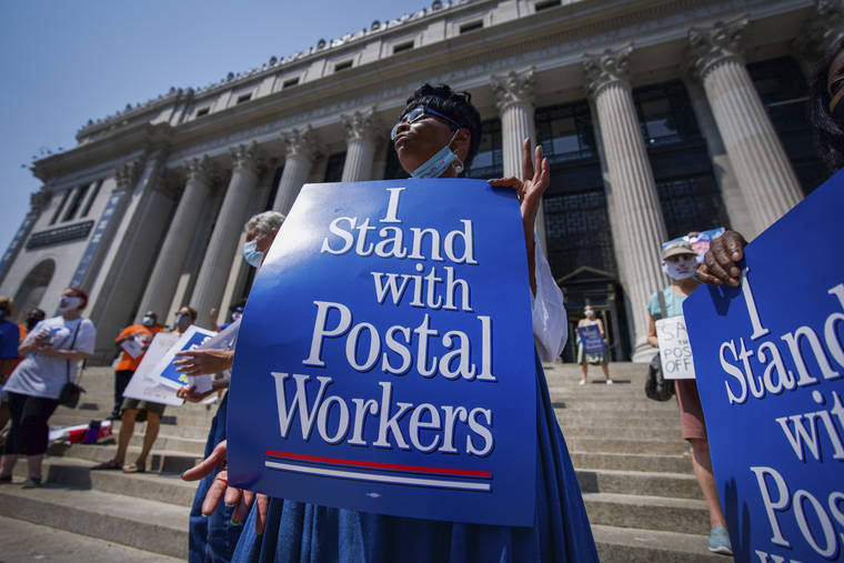 ASSOCIATED PRESS
                                Retired postal worker Glenda Morris protests postal cutbacks in New York. Postmaster General Louis DeJoy told lawmakers Monday that he has warned allies of President Donald Trump that the president’s repeated attacks on the legitimacy of mail-in ballots are “not helpful,” but denied that recent changes at the Postal Service are linked to the November elections.