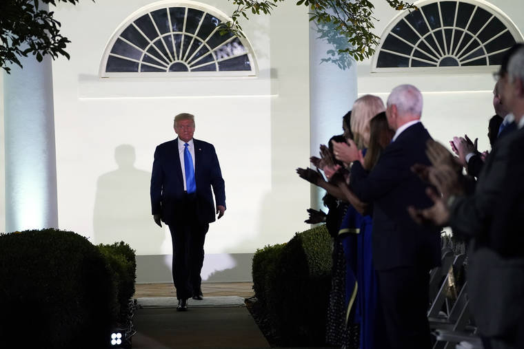 ASSOCIATED PRESS
                                President Donald Trump arrives to listen to first lady Melania Trump speak during the 2020 Republican National Convention from the Rose Garden of the White House on Tuesday in Washington.