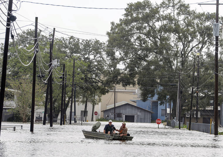 BRAD BOWIE/THE ADVOCATE VIA ASSOCIATED PRESS
                                Boaters navigated a flooded road following Hurricane Laura, Thursday, in Delcambre, La.
