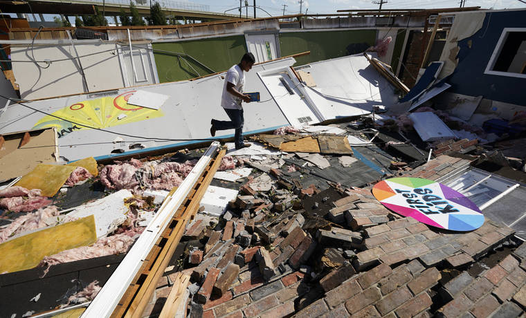 ASSOCIATED PRESS
                                Benjamin Luna helped recover items from the children’s wing of the First Pentecostal Church that was destroyed by Hurricane Laura, Thursday, in Orange, Texas.