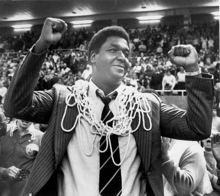 ANESTIS DIAKOPOULOS/PROVIDENCE JOURNAL VIA ASSOCIATED PRESS / MARCH 1980
                                Georgetown University basketball coach John Thompson raised his hands in victory after fans placed the net around his neck in Providence, R.I., after Georgetown defeated Syracuse University 87-81 to win the Big East basketball championship. Thompson, the imposing Hall of Famer who turned Georgetown into a “Hoya Paranoia” powerhouse and became the first Black coach to lead a team to the NCAA men’s basketball championship, has died.