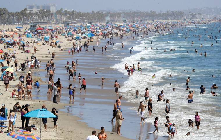 ASSOCIATED PRESS
                                Visitors crowded the beach, July 12, in Santa Monica, Calif., amid the coronavirus pandemic. A heatwave brought crowds to California’s beaches as the state grappled with a spike in coronavirus infections and hospitalizations.