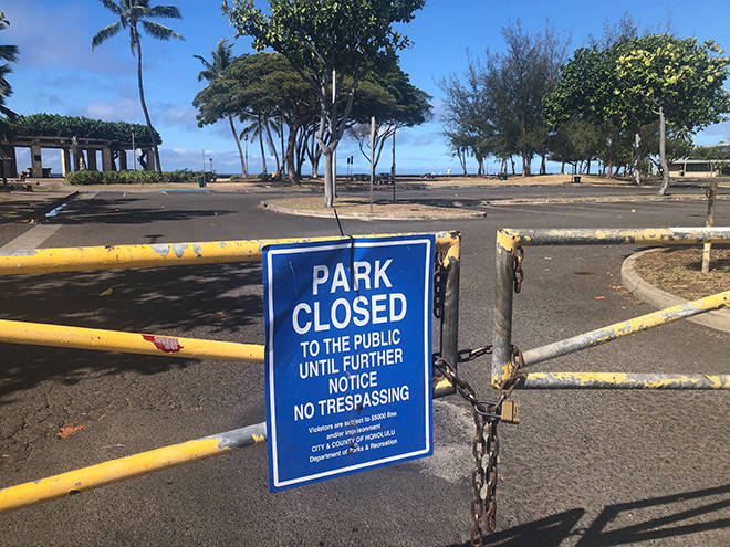 CRAIG T. KOJIMA / CKOJIMA@STARADVERTISER.COM
                                The parking lot of Kewalo Basin was closed today as the city began enforcing the closures of parks and beaches in response to the resurgence of coronavirus cases on Oahu.