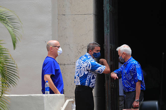 JAMM AQUINO / @JAQUINO@STARADVERTISER.COM
                                Honolulu Mayor Kirk Caldwell, right, elbow bumps City Council Chairman Ikaika Anderson as Dr. Scott Miscovich looks on at left, today in front of Honolulu Hale.