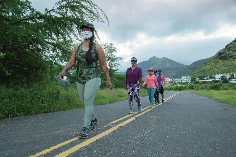 CRAIG T. KOJIMA / CKOJIMA@STARADVERTISER.COM
                                <strong>“I told the girls that sounds like something we can do, where you just do it on your own.”</strong>
                                <strong>Margaret Jones</strong>
                                <em>Pictured above leading her group on a walk Friday on Kaihoolulu Street Access Road in Maili. The 61-year-old had never done the Heart Walk before but took advantage of this year’s “digital experience.”</em>